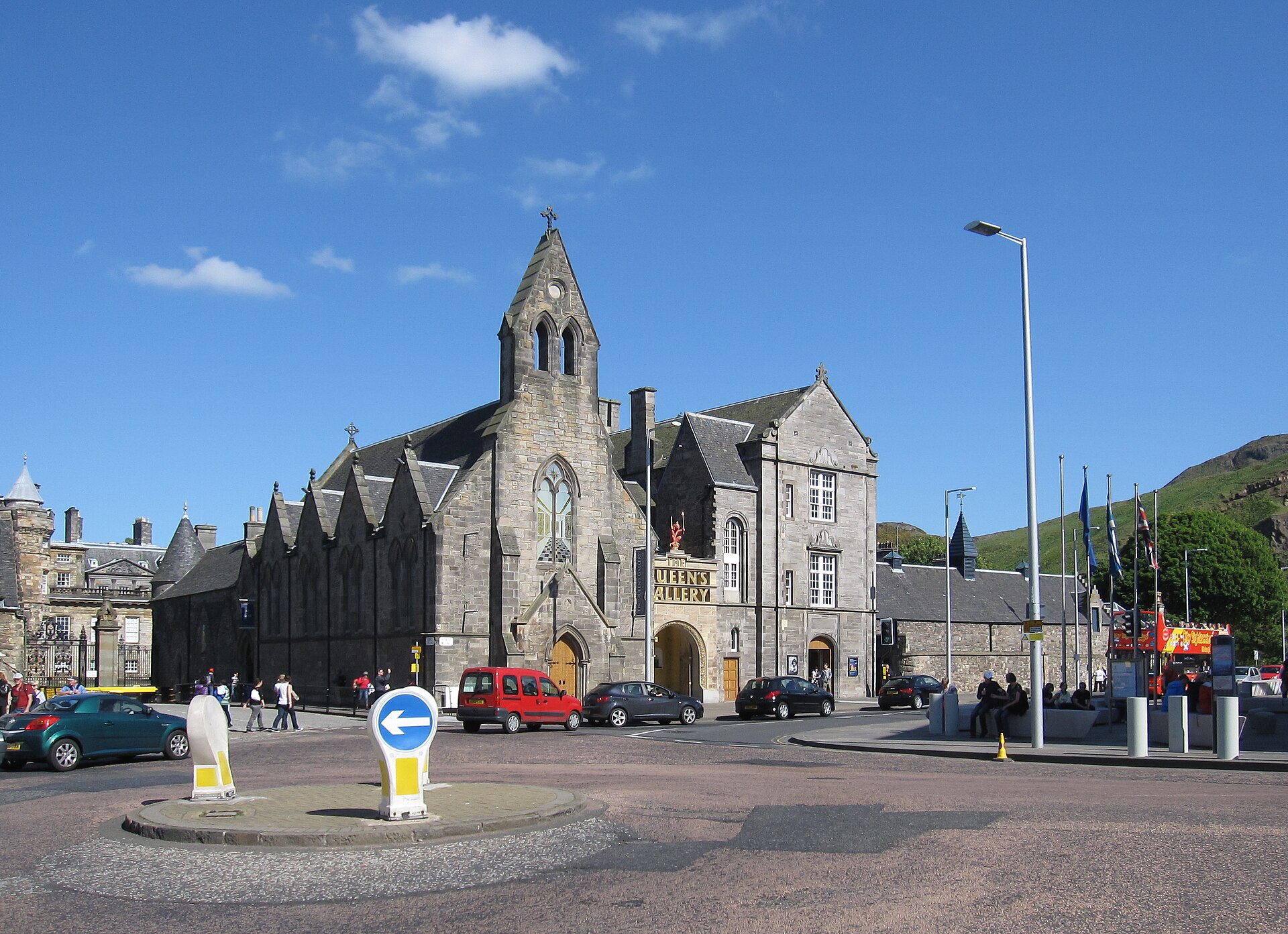 The stone towers and east range of the Palace of Holyroodhouse beside lawns and flower beds